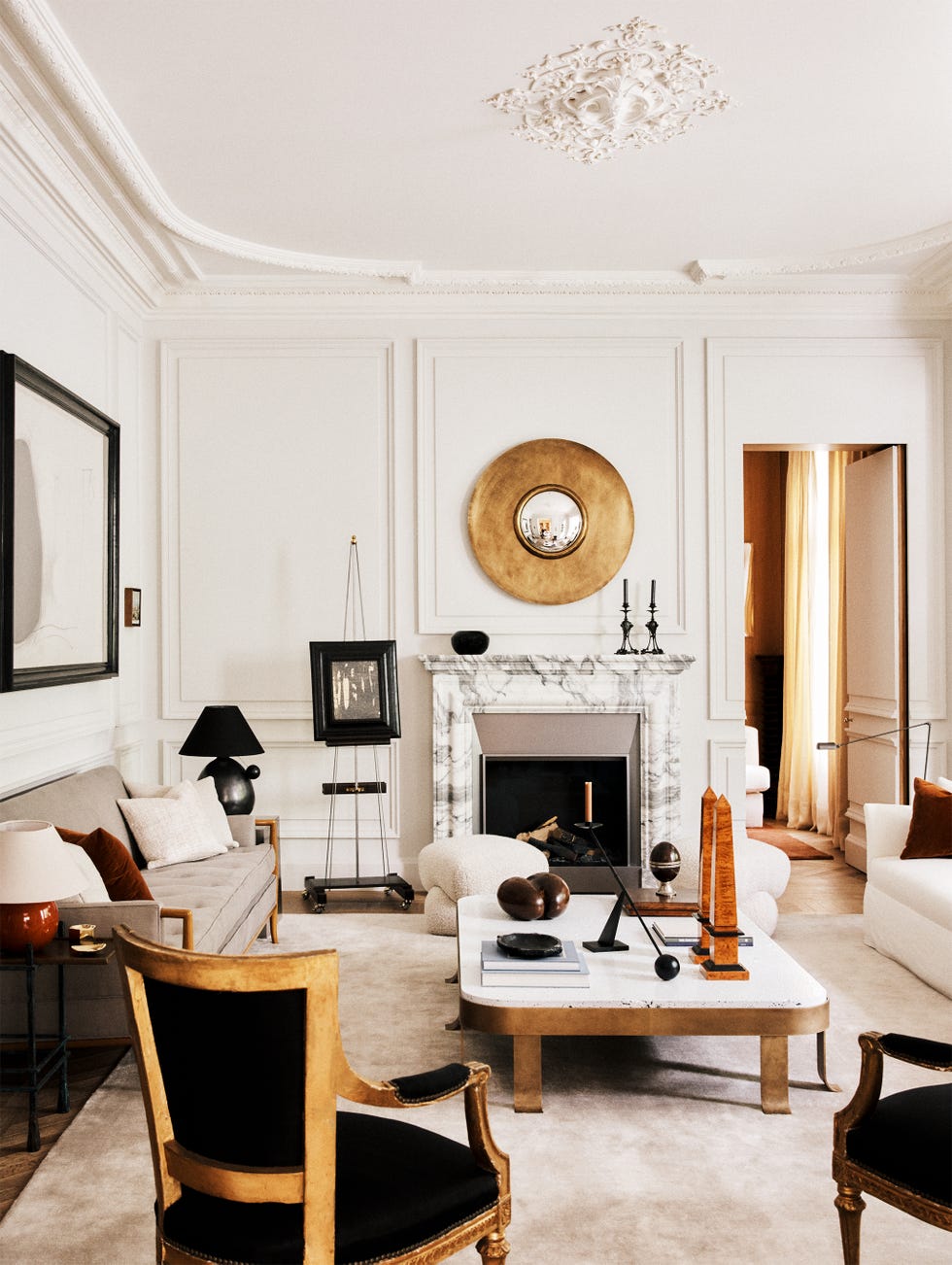 Stylish living room with elegant decor, including a fireplace, modern furniture, and decorative art pieces.