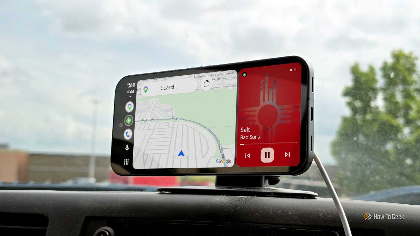 Android Auto on phone screen showing the maps app and music..