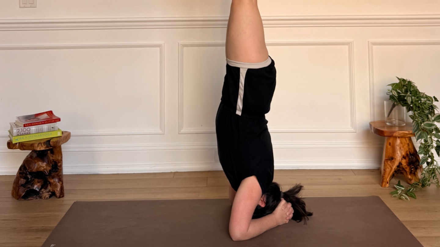 Purdon showing headstand on yoga mat