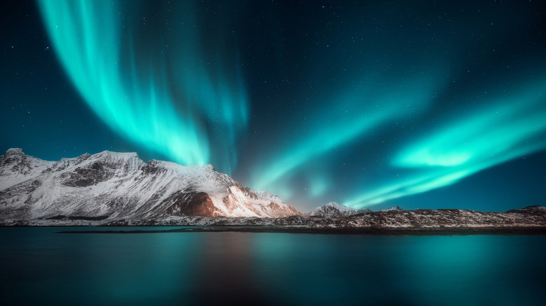 Aurora Borealis over snowy mountains in Norway