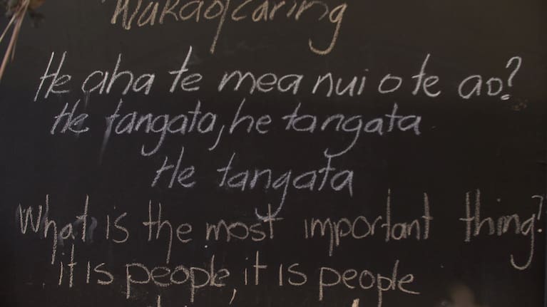 A blackboard sign at the Waka of Caring food bank with Māori proverb: 'He aha te mea nui o te ao, he tangata... what is the most important thing, it is people.'