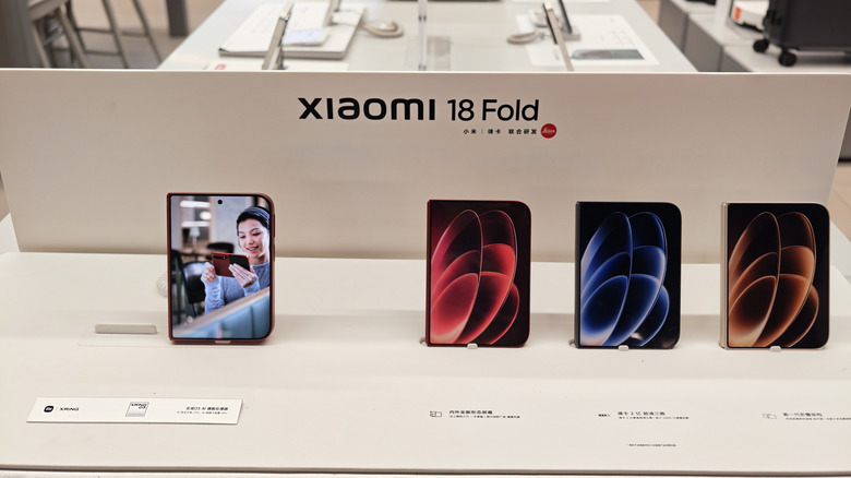 The Xiaomi 18 Fold in different colors on a store table.