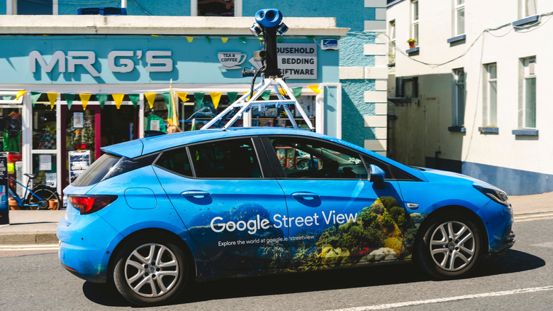 A blue Google Street View car captures street imagery.
