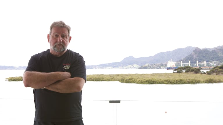 Captain Paul Hines at home beside the ecologically important Blacksmiths Creek and Whangārei's existing busy port