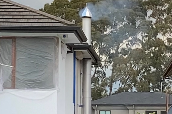 Smoke comes from a chimney