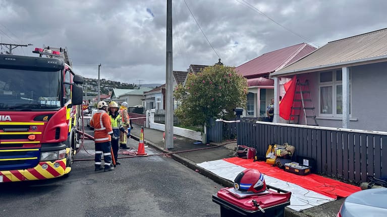 Crews at the scene of a house fire in Dunedin. 
