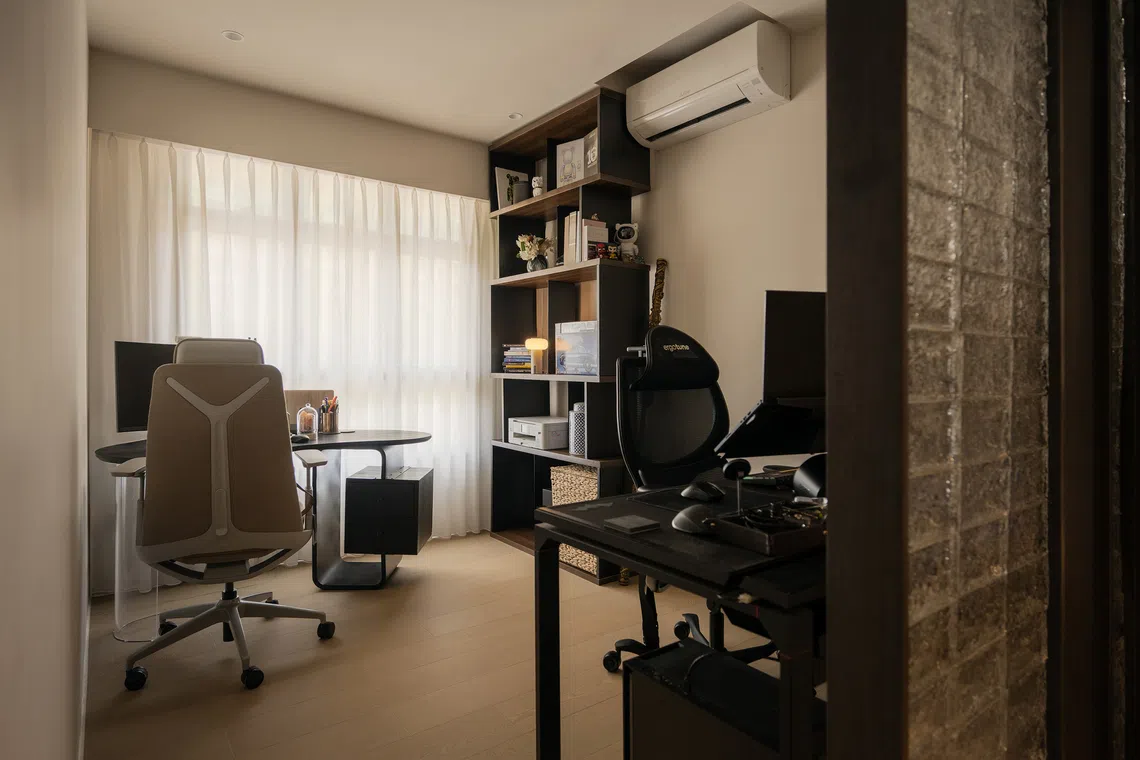 A glass block divider lets light into the study, separating spaces while preserving openness.