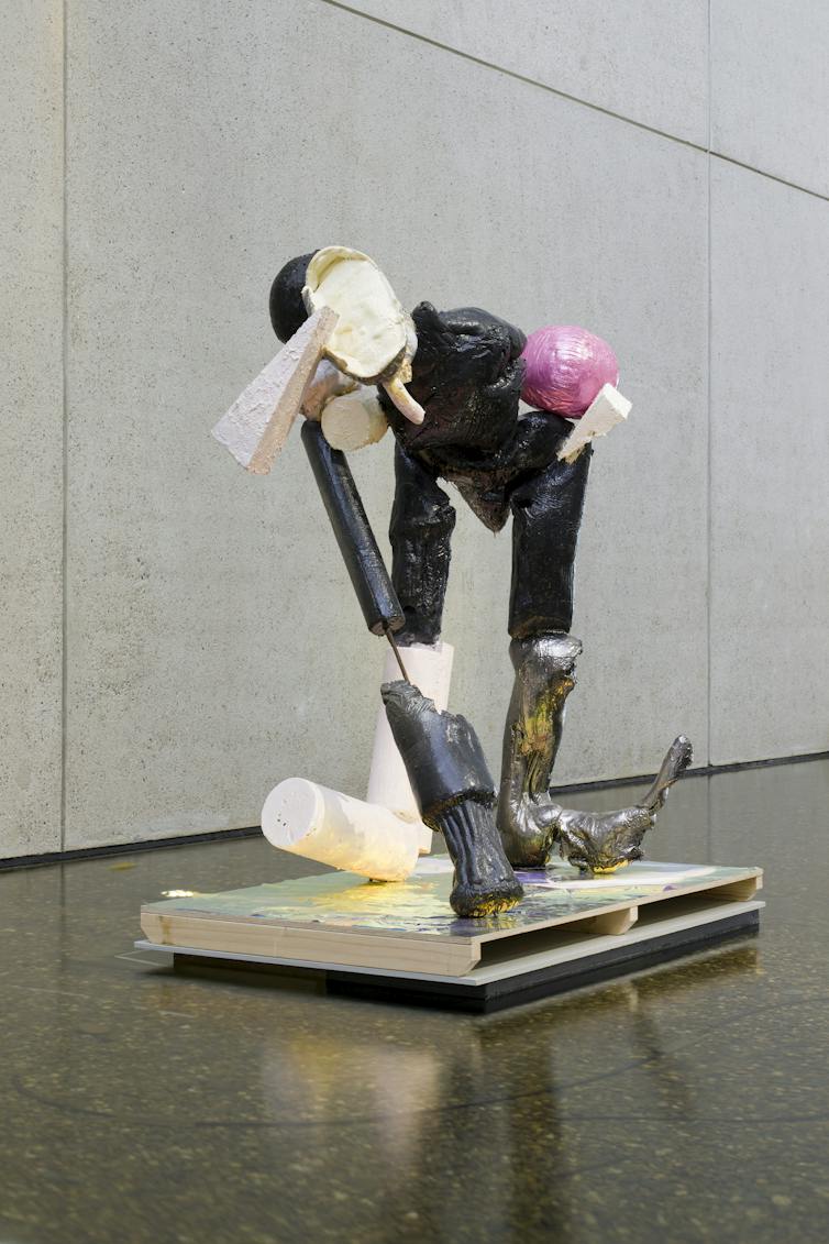 A weird human-ish sculpture of found objects.