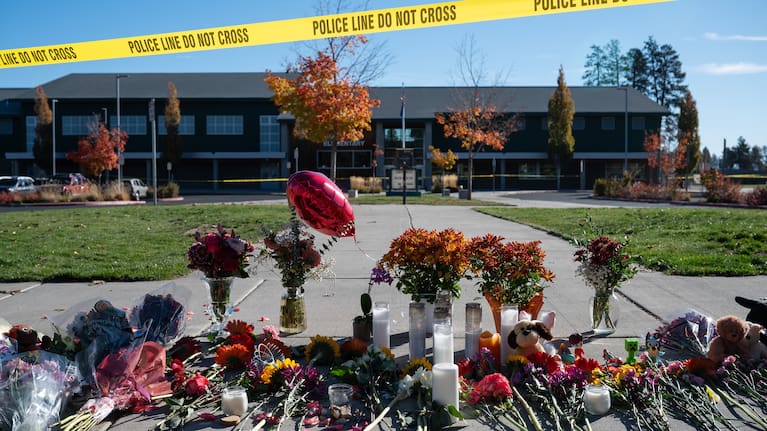 Flowers and candles are seen at a makeshift memorial outside Silver Rail Elementary.