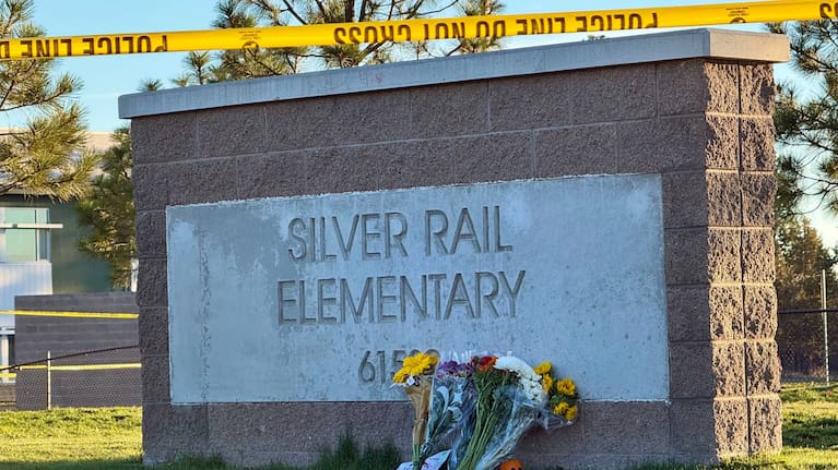 Flowers are placed beside a sign at Silver Rail Elementary School in Bend, Oregon, on Friday, October 16, 2026, a day after a deadly shooting.