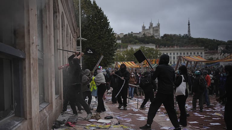 Protesters attack a tourism office during a demonstration against rising living costs, joining students' grievances, in Lyon
