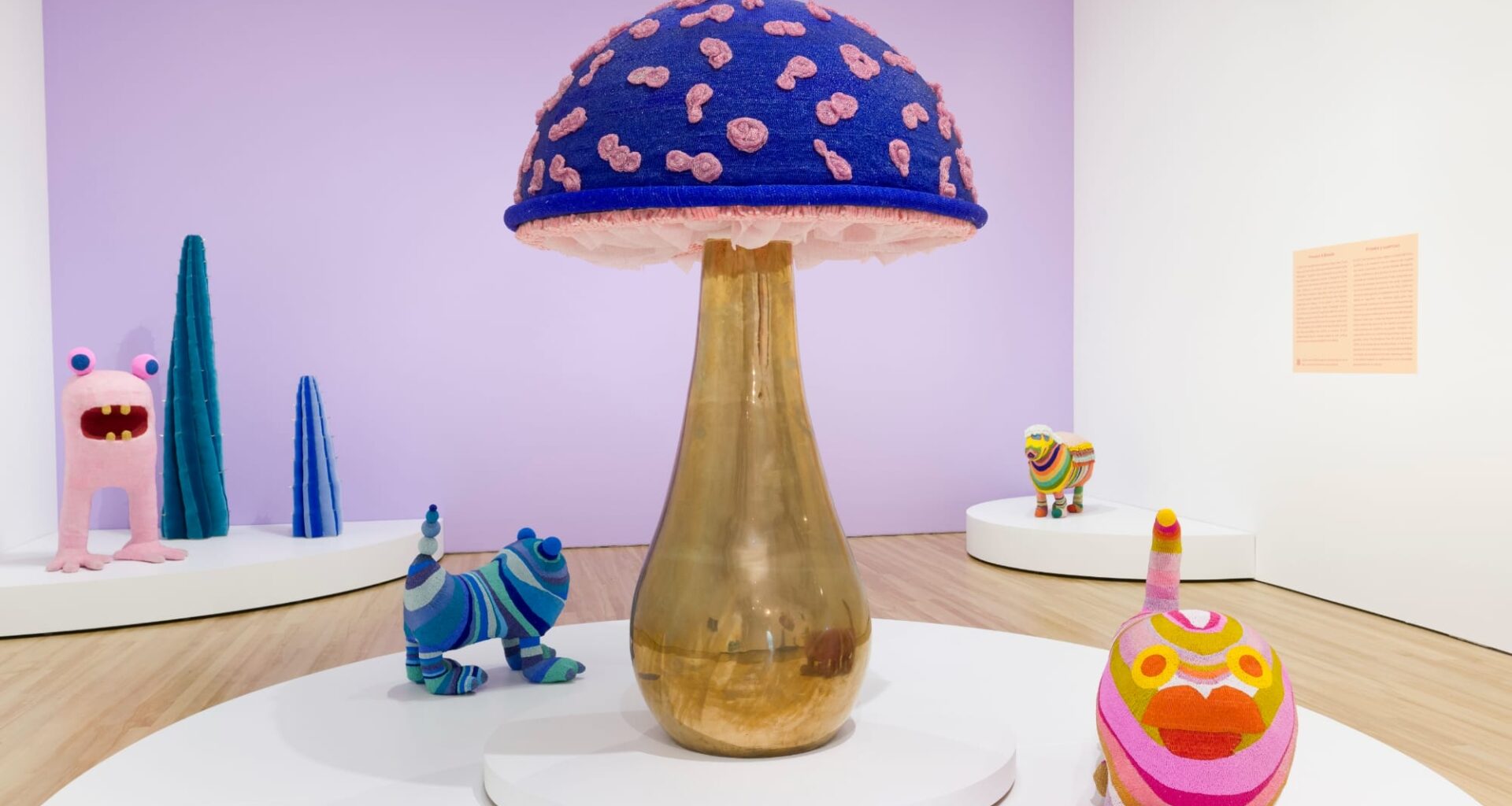 fantastical creatures and a large gold and purple mushroom by the haas brothers