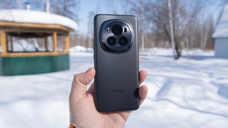 A man holding an Honor Magic6 Pro