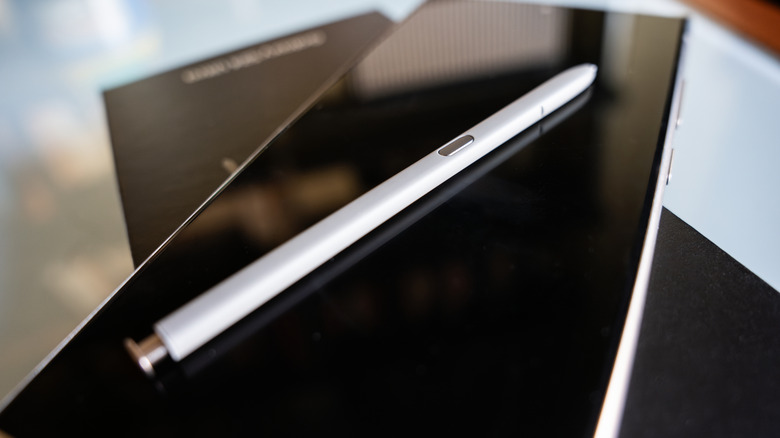 A Samsung S Pen resting on top of a Galaxy S24 Ultra with the screen off.