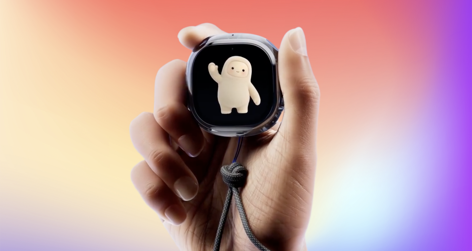 A hand holding the Muse Charm on a rainbow background