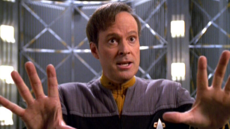 Reginald Barclay (Dwight Schultz) holds up his hands in Star Trek: Voyager