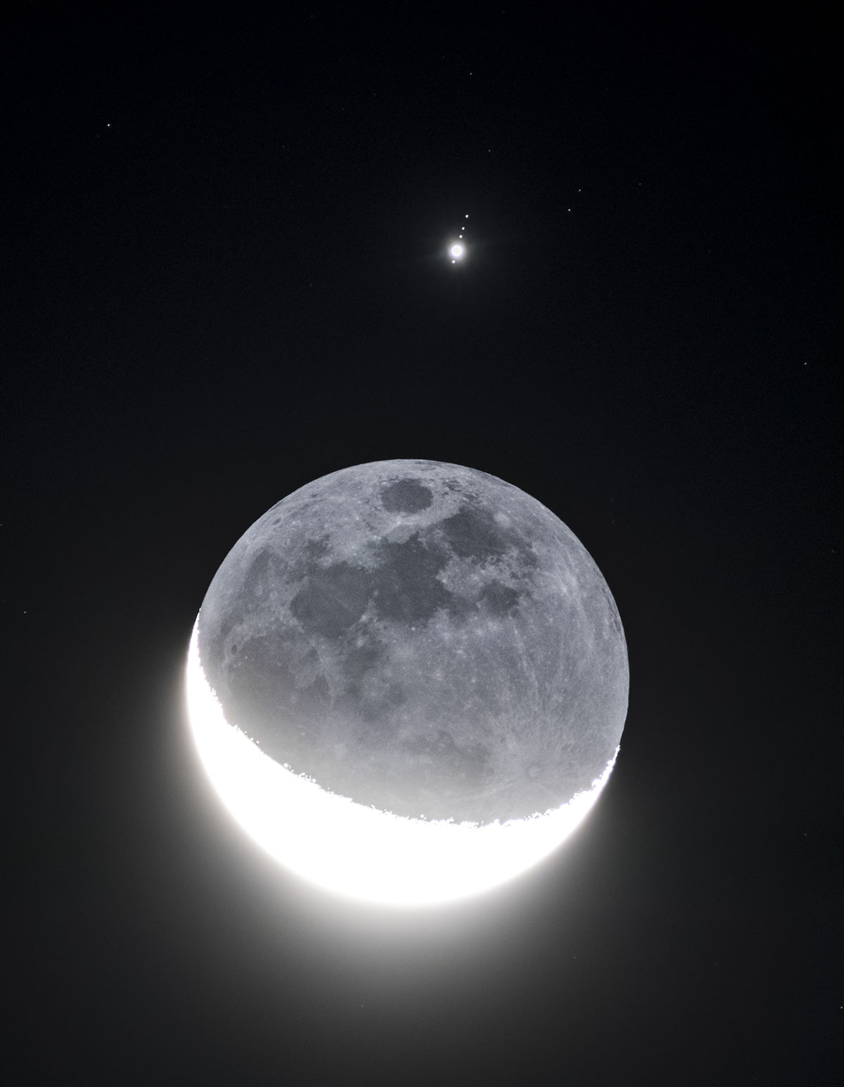 A view of the crescent Moon and Jupiter, with Jupiter's Galilean moons on view, captured by Chirag Upreti from Westchester, New York, USA, 6 October 2026. Equipment: Sony A7R3 camera, Sony 200–600mm lens, 2X extender. Exposure: ISO 3200, f/16, 1/3s