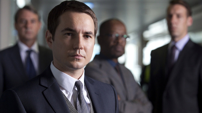 Steve (Martin Compston) surrounded by colleagues on 