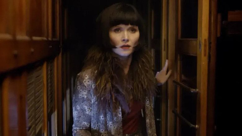 Phryne Fisher (Essie Davis) walking down a hallway on "Miss Fisher's Murder Mysteries."