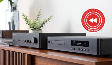 NAD C 359S streaming amp and C 56 CD player sitting next to each other on a sideboard with a red Rewind roundel in the top right corner of the image