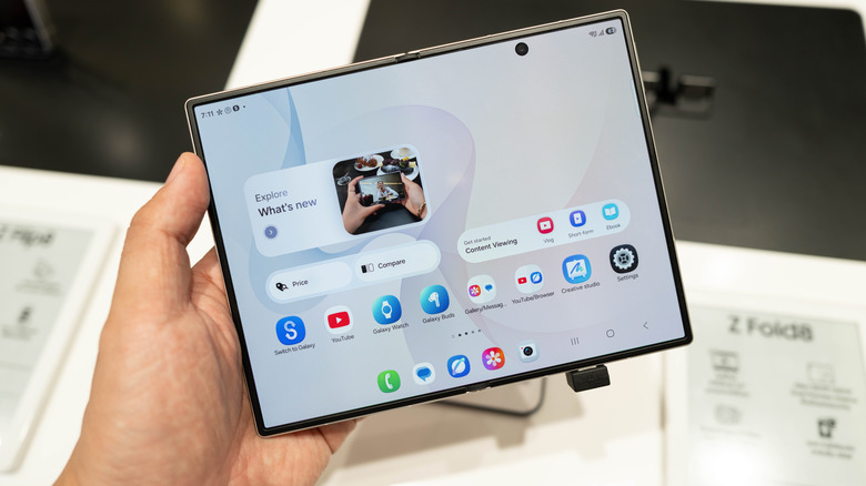 A person holding the Galaxy Z Fold 8 smartphone at a store in Bangkok