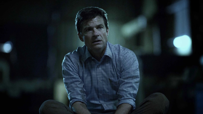 Jason Bateman as Marty Byrde, tied up on the ground in Ozark.