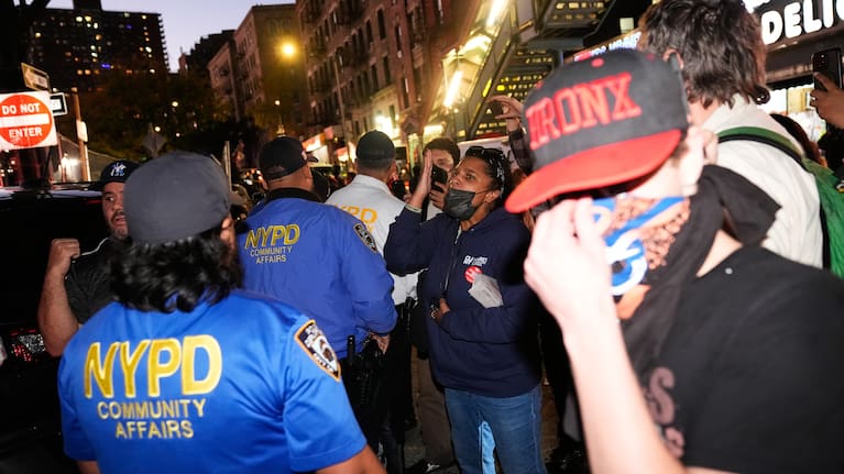 People confront law enforcement near the scene of a shooting
