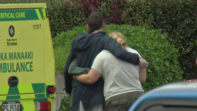 People embrace following an incident in Auckland's Glen Innes.