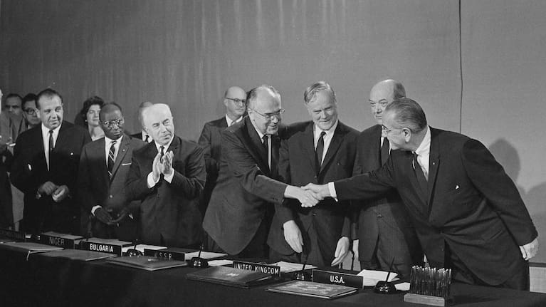 President Lyndon Johnson, right, reaches over to shake the hand of Soviet Ambassador to the United States Anatoly Dobrynin after signing of treaty to bar nuclear weapons from space, during a ceremony in 1967.