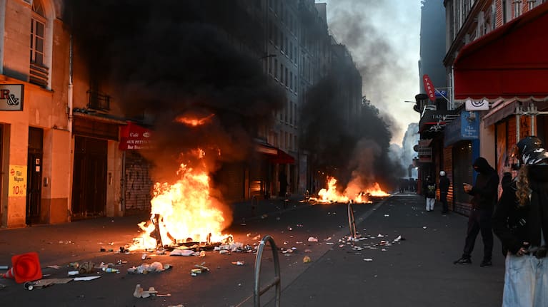 Protesters burn trash during clashes with police the day after a demonstration against rising living costs, joining students' grievances, in Paris, Sunday, Oct. 18, 2026.
