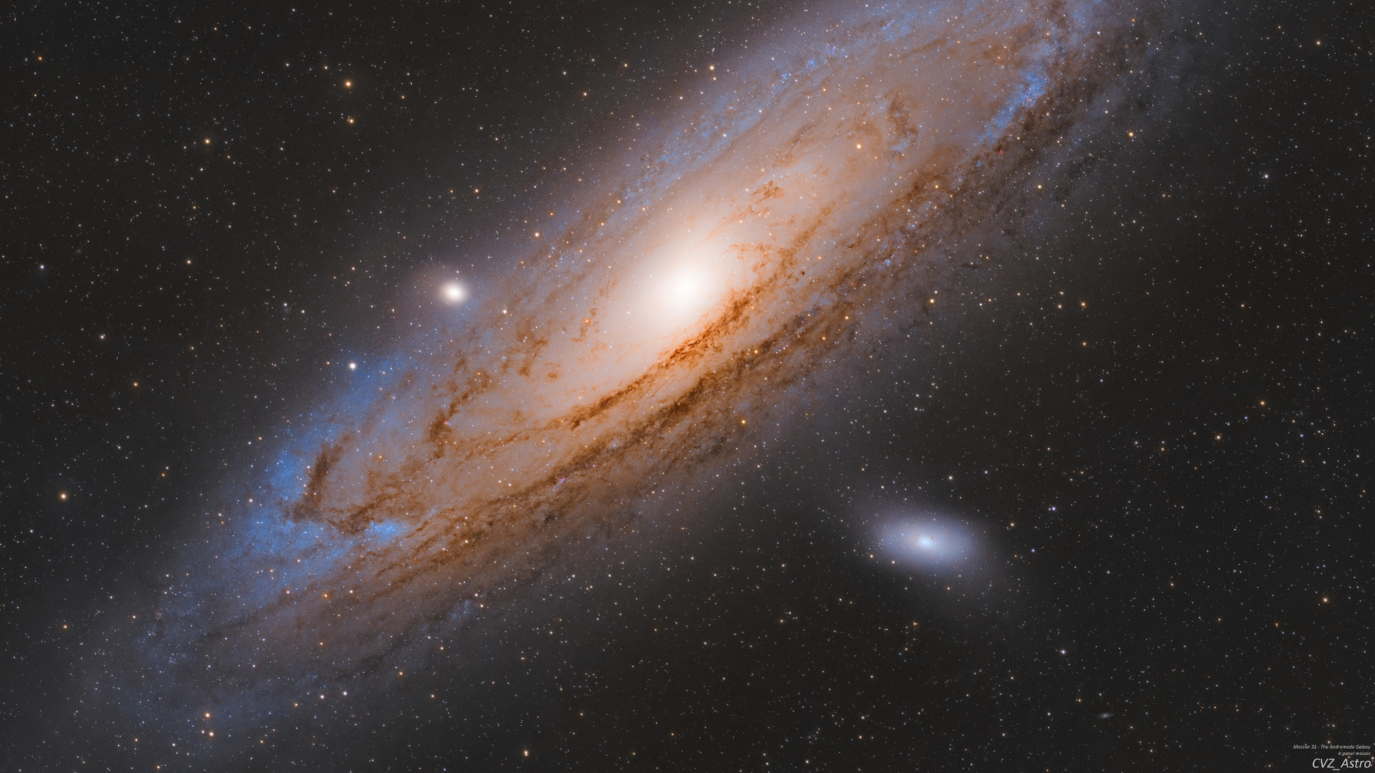 A spiral galaxy glows against a distant starfield in the blackness of space