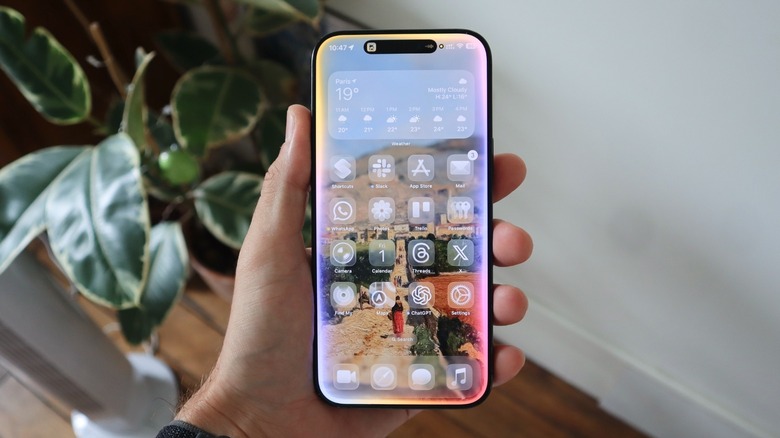 A hand holding an iPhone with the previous Apple Intelligence interface
