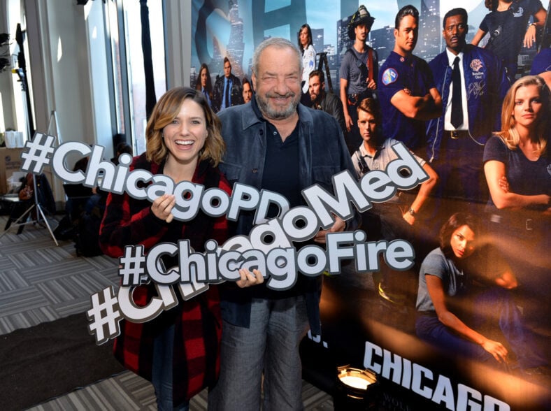 Sophia Bush and Executive Producer Dick Wolf pose with hashtags at a press junket for NBC's 'Chicago Fire', 'Chicago P.D.' and 'Chicago Med' at Cinespace Chicago Film Studios on November 9, 2015 in Chicago, Illinois