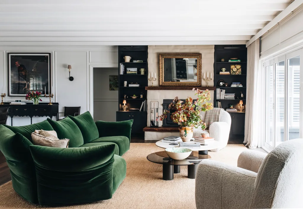 A living space with a large jute rug and a statement green velvet sofa