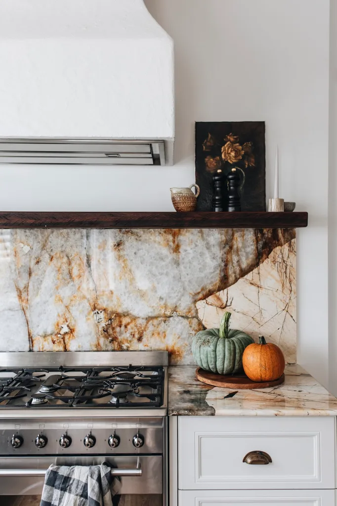 A stone kitchen bench with two pumpkins
