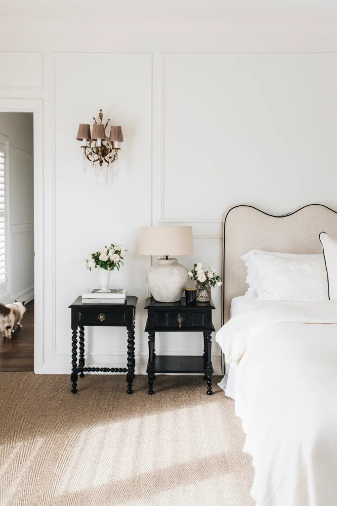 A white bedroom with two bedside tables