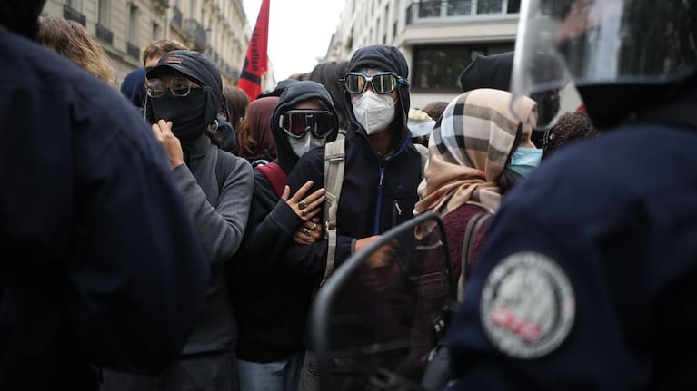 Students face policemen near Sciences Po University as they protest against under-resourced schools, in Paris, Wednesday. 