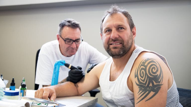 Tanner and Hauraki District Council mayor Toby Adams are bonded by the ink pen.