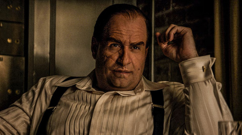 Colin Farrell as Oz Cobb, sitting in a chair in The Penguin.