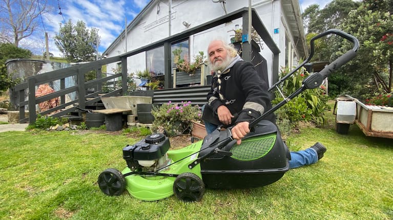 Third generation 1 Whananaki Wharf Road bach owner Brian Meadows outside his home with his new lawnmower.
