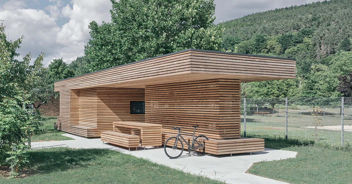 tob.studio’s timber bike station in germany resembles stacked log pile