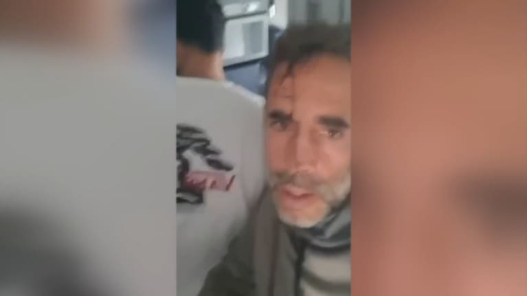 Video shared from the cabin showed a pilot with blood on his shirt being treated in the aisle.