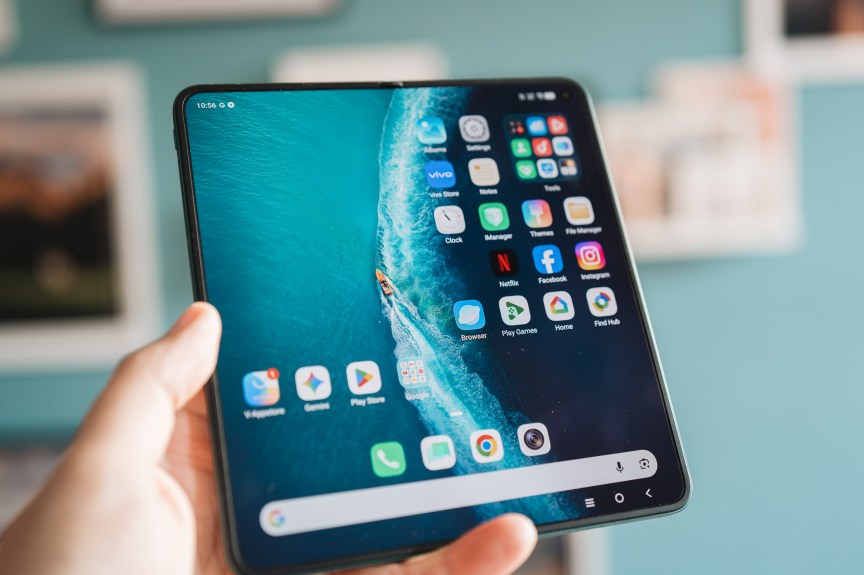 A hand holds an unfolded Vivo X Fold 6, drawing attention to the screen.