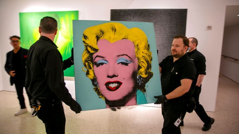 The 1964 painting Shot Sage Blue Marilyn by Andy Warhol is carried in Christie's showroom in New York City on Sunday.