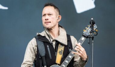 Matt Heafy on stage looking serious with a guitar