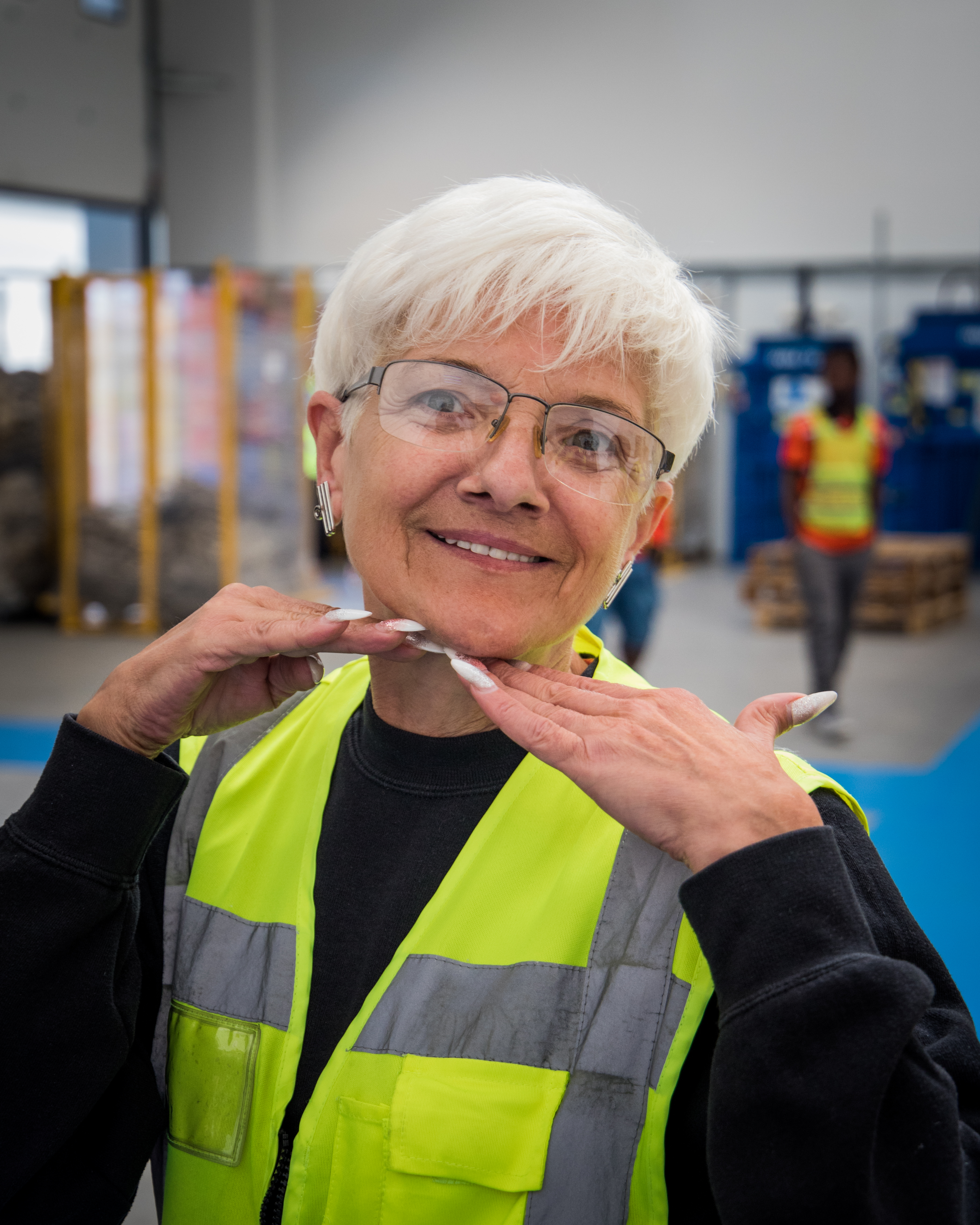 Portrait of Iwona, a smiling Woolcool team member wearing a safety vest.