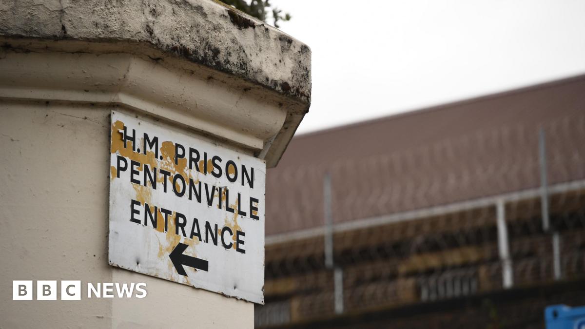 A sign on a column saying H.M. Prison Pentonville, and underneath the words Entrance and an arrow pointing to the left.