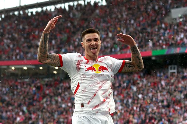 Benjamin Sesko of RB Leipzig celebrates scoring his team's second goal during the Bundesliga match against FC Augsburg