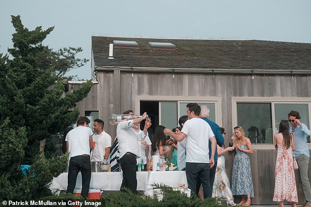 This trend isn't a dirty little secret among the high prowlers of society, but an open beauty hack. Pictured: stock image of a 2023 Hamptons party