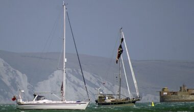 A kite surfer has died following a 'freak accident' where he was reportedly blown out of the water in high winds and thrown into the side of a moored yacht